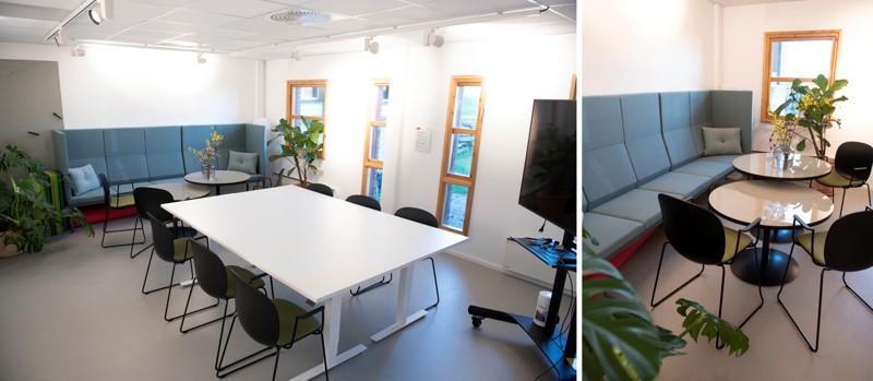 Møterom med bord, stoler, sofa langs vegg med tilhørende småbord. 