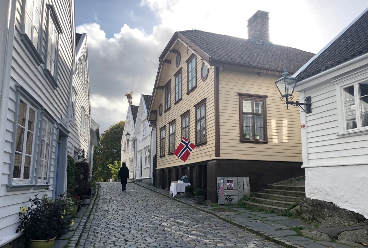 gatebilde med okerfarget hus blant mange hvite trehus