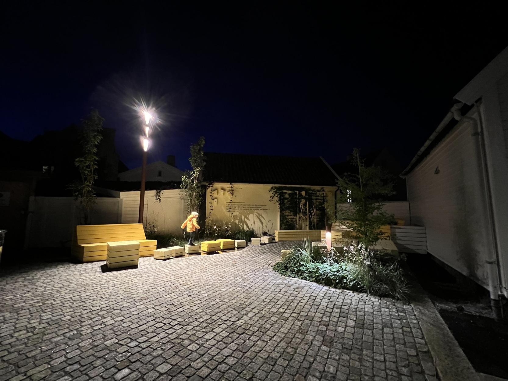 Lite barn leker i parken på kveldstid