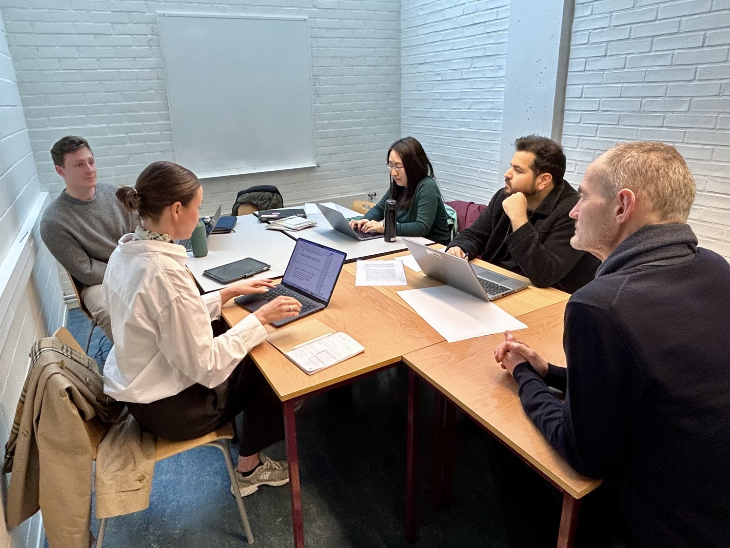 PhD-studentene Christina N. Larsen, Tommy Galliver, Grace Zhou og Fasih Munir, diskuterer løsninger for ombruk av bygg med byarkitekt Henrik Lundberg.