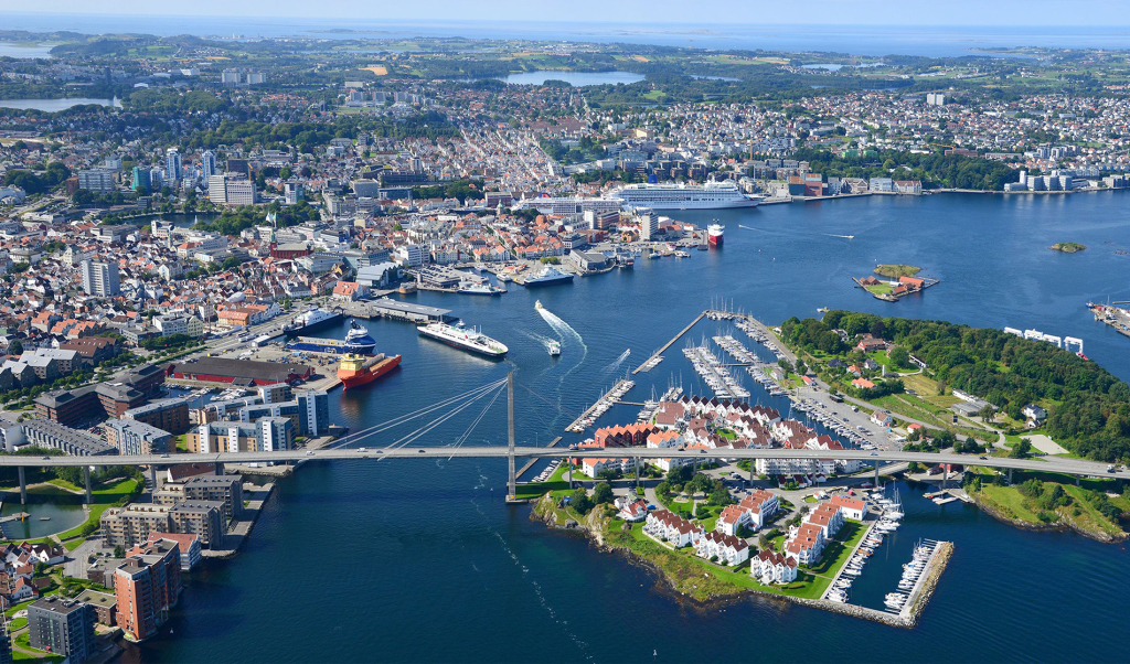 Vi ser et flyfoto over Stavanger. I forgrunnen vises Sjølyst, bybrua og sjøfronten av Storhaug. Bak ligger resten av byen.