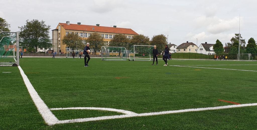 Ungdommer sparker fotball på nytt kunstgress på Kvaleberg. I bakgrunnen ligger Kvaleberg skole.